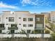 Modern townhouse featuring a clean white facade, balconies, and stylish architectural details at 1717 E Morten Ave # 2, Phoenix, AZ 85020