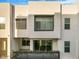 Modern townhouse with a clean, contemporary facade and balcony with foliage at 1717 E Morten Ave # 2, Phoenix, AZ 85020