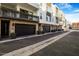 Modern townhome with brick accents, black garage door, and lush green landscaping at 1717 E Morten Ave # 2, Phoenix, AZ 85020