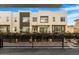 Exterior facade with large window placements, balconies, and privacy bushes at 1717 E Morten Ave # 2, Phoenix, AZ 85020