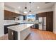 Modern kitchen features stainless steel appliances, quartz countertops, and dark wood cabinetry at 1717 E Morten Ave # 2, Phoenix, AZ 85020