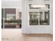 Living room with large windows and tile floors offering courtyard views at 1717 E Morten Ave # 2, Phoenix, AZ 85020