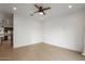Spacious living room featuring tile floors, a ceiling fan, and view to the kitchen at 1717 E Morten Ave # 2, Phoenix, AZ 85020
