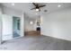 Open living room with light tile floors, a ceiling fan, and kitchen at 1717 E Morten Ave # 2, Phoenix, AZ 85020