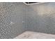 Outdoor community shower area with mosaic tile walls and stone flooring at 1717 E Morten Ave # 2, Phoenix, AZ 85020