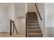 Carpeted staircase with white walls and metal and wood banisters at 1717 E Morten Ave # 2, Phoenix, AZ 85020