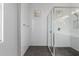 Bright bathroom shower with white tiled walls and a dark tiled shower floor at 21031 W Elm Way Ct, Buckeye, AZ 85396