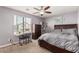 Bedroom with a ceiling fan, dark wood furnishings, and a map accenting a comfortable space at 25420 W Park Ave, Buckeye, AZ 85326
