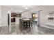Cozy dining area featuring stylish lighting and easy access to the kitchen and backyard at 25420 W Park Ave, Buckeye, AZ 85326