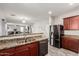 Open kitchen design with granite countertops, stainless appliances, and seamlessly integrates with living space at 25420 W Park Ave, Buckeye, AZ 85326