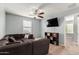 Cozy living room features plush sectional sofa, ceiling fan, and wall-mounted TV for relaxing at home at 25420 W Park Ave, Buckeye, AZ 85326