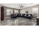 Spacious living room featuring marble floors, a ceiling fan, and a comfortable sectional sofa at 25420 W Park Ave, Buckeye, AZ 85326