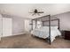 Comfortable main bedroom with a four-poster bed and neutral gray tones for a relaxing atmosphere at 25420 W Park Ave, Buckeye, AZ 85326