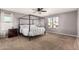 Bright main bedroom features a four poster bed frame, carpeted floors, and natural light at 25420 W Park Ave, Buckeye, AZ 85326