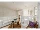 Neutral upstairs hallway with white railing and comfortable seating area at 26815 N 65Th Ave, Phoenix, AZ 85083