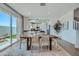 Dining area featuring a modern wood table with chairs, rug, and sliding glass doors to the outdoor area at 2938 N 98Th Ln, Phoenix, AZ 85037