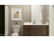 Cozy bathroom with warm neutral colors and a contemporary vanity with modern fixtures at 2940 N 98Th Ln, Phoenix, AZ 85037