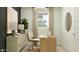 A modern home office featuring a sleek wooden desk, stylish decor, and a comfortable chair at 2940 N 98Th Ln, Phoenix, AZ 85037