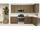 Modern kitchen with stainless steel appliances, ample countertop space, and stylish cabinetry at 2940 N 98Th Ln, Phoenix, AZ 85037