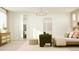 A stylish main bedroom features a comfortable seating area and modern decor at 2940 N 98Th Ln, Phoenix, AZ 85037