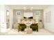 Beautifully decorated main bedroom with a cozy seating area and a decorative mirror at 2940 N 98Th Ln, Phoenix, AZ 85037
