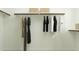 Bright walk-in closet with well-organized storage, clothing rods, and shelving at 2940 N 98Th Ln, Phoenix, AZ 85037