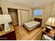 Cozy bedroom with a wood frame bed, sliding door closet, and wood laminate flooring at 305 S Val Vista Dr # 169, Mesa, AZ 85204