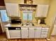 Classic kitchen showcasing ample cabinet space, countertop, and stainless steel sink, providing a practical area at 305 S Val Vista Dr # 169, Mesa, AZ 85204