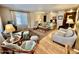 Bright living room with a cozy seating arrangement, hardwood floors, and large windows for ample sunlight at 305 S Val Vista Dr # 169, Mesa, AZ 85204