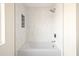 Clean bathroom featuring a shower over a tub, white subway tile, and a built-in niche at 3141 E Hillery Dr, Phoenix, AZ 85032