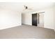 Spacious bedroom with neutral carpet, a sliding barn door, and ample natural light at 3141 E Hillery Dr, Phoenix, AZ 85032