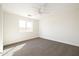 Comfortable carpeted bedroom features a ceiling fan and a window providing natural light at 3141 E Hillery Dr, Phoenix, AZ 85032
