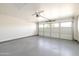 Clean and spacious two-car garage with an epoxy floor and automatic door opener at 3141 E Hillery Dr, Phoenix, AZ 85032