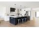 Beautiful kitchen with white cabinets, black island, stainless steel appliances, and wood flooring at 3141 E Hillery Dr, Phoenix, AZ 85032
