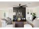 Bright living room features modern decor, neutral furniture, black fireplace and hardwood floors at 3141 E Hillery Dr, Phoenix, AZ 85032