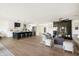 Open-concept living space featuring a modern kitchen, living room with fireplace and hardwood floors at 3141 E Hillery Dr, Phoenix, AZ 85032