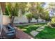 Landscaped backyard featuring a brick patio and stone walkway at 3229 E Malapai Dr, Phoenix, AZ 85028