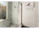 Beautiful, bright bathroom with marble tile shower, pebble floor, and glass door at 3229 E Malapai Dr, Phoenix, AZ 85028