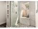 Beautiful bathroom showcases tiled shower, unique flooring, and built in shelving at 3229 E Malapai Dr, Phoenix, AZ 85028