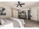 Bedroom featuring carpet flooring, ceiling fan, ensuite bathroom and decorative dresser at 3229 E Malapai Dr, Phoenix, AZ 85028