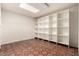 Bright bedroom with full wall built-in shelving and terracotta tiled flooring at 3229 E Malapai Dr, Phoenix, AZ 85028