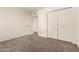 Comfortable carpeted bedroom with closet and ensuite bathroom at 3229 E Malapai Dr, Phoenix, AZ 85028