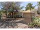 Attractive property featuring a unique sunshade, stone accents, desert landscaping, and a welcoming driveway at 3229 E Malapai Dr, Phoenix, AZ 85028