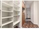 Hallway view with built-in shelving and terracotta tiled flooring at 3229 E Malapai Dr, Phoenix, AZ 85028