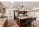Well-equipped kitchen featuring a granite island, stainless steel appliances, and dark wood cabinetry at 3229 E Malapai Dr, Phoenix, AZ 85028