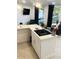 Modern kitchen island with white cabinets and a sleek cooktop, perfect for entertaining at 3229 E Malapai Dr, Phoenix, AZ 85028