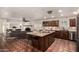 Open kitchen featuring granite countertops, dark wood cabinets, and seamless flow to the living room at 3229 E Malapai Dr, Phoenix, AZ 85028