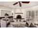 Bright living room highlighting a brick fireplace, comfortable chairs, and ample natural light at 3229 E Malapai Dr, Phoenix, AZ 85028