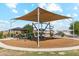 This is an outdoor playground featuring climbing structure, shade and picnic facilities, and landscaping at 36001 W San Ildefanso Ave, Maricopa, AZ 85138