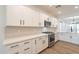 Modern kitchen showcasing white cabinets, quartz countertops, stainless steel appliances, and sleek hardware at 3653 E Sweetclover Ln, San Tan Valley, AZ 85140